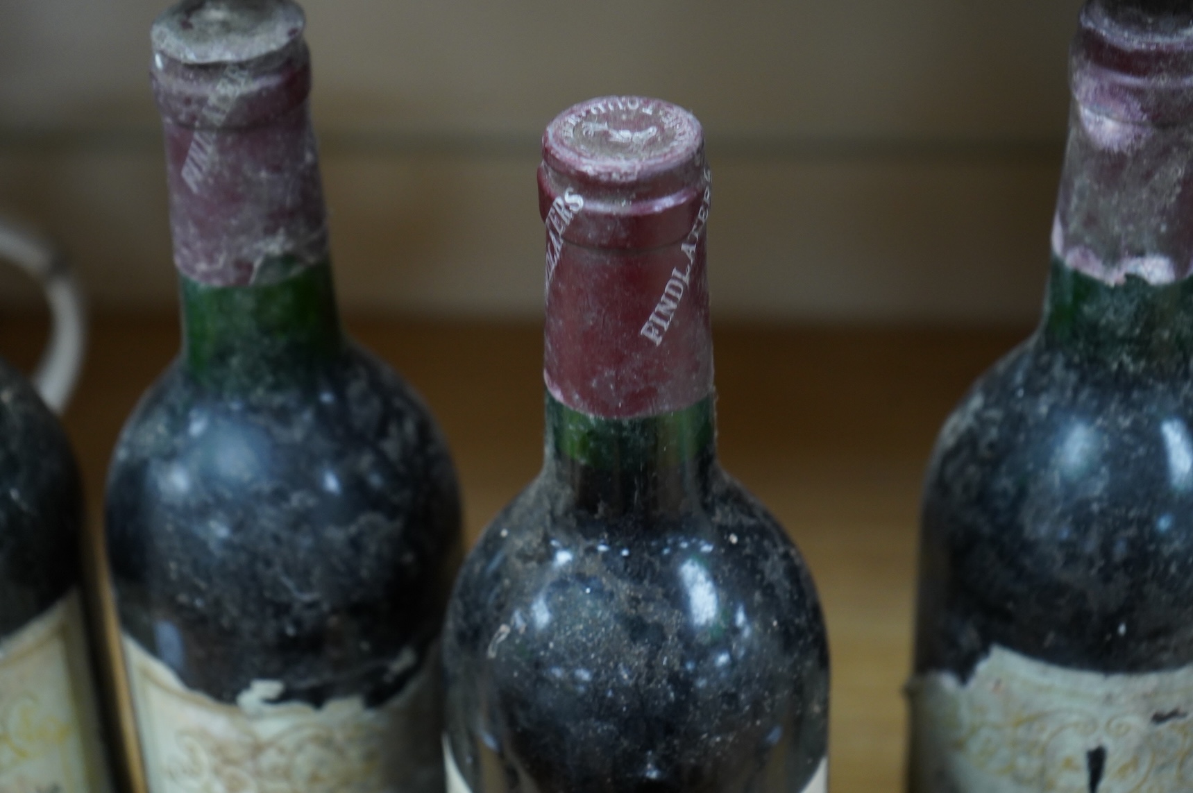 Five bottles of Chateau Cantemerle, 1975, labels degraded